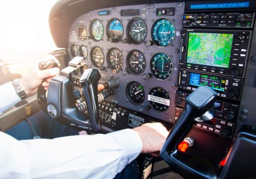 PRAGUE, CZECH REPUBLIC - 9.09.2017: Hand of pilot on handwheel in small plane and dashboard in sky over Prague